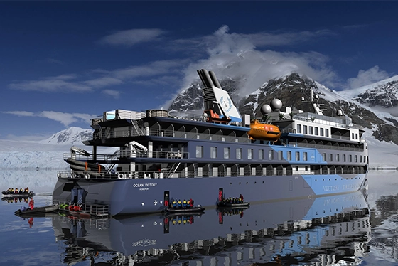 Cruise Ship Navigating Icy Waters Near Snow-Capped Mountains in Ohio Travel Scene