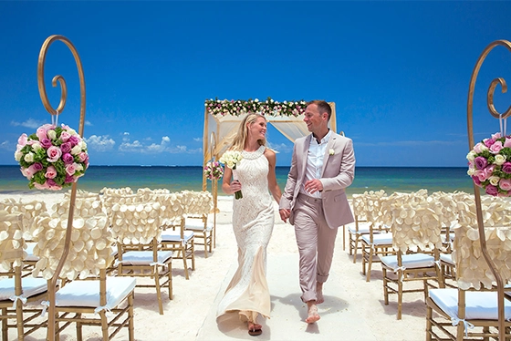 Couple Walking Down Beach Aisle After Wedding Ceremony, Clear Blue Sky