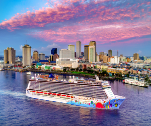 Cruise Ship Approaching City Skyline at Sunset with Vibrant Clouds