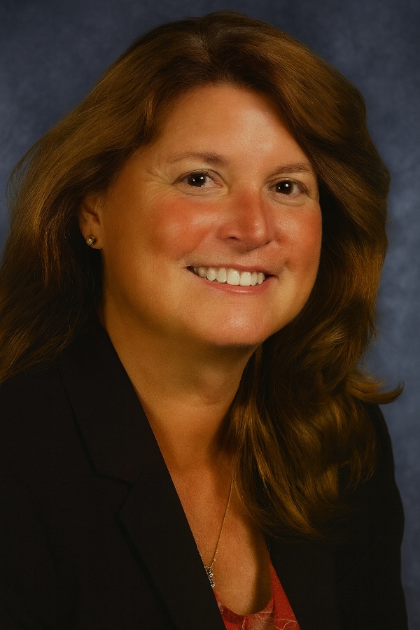 Smiling Woman in Professional Attire Against a Blue Background